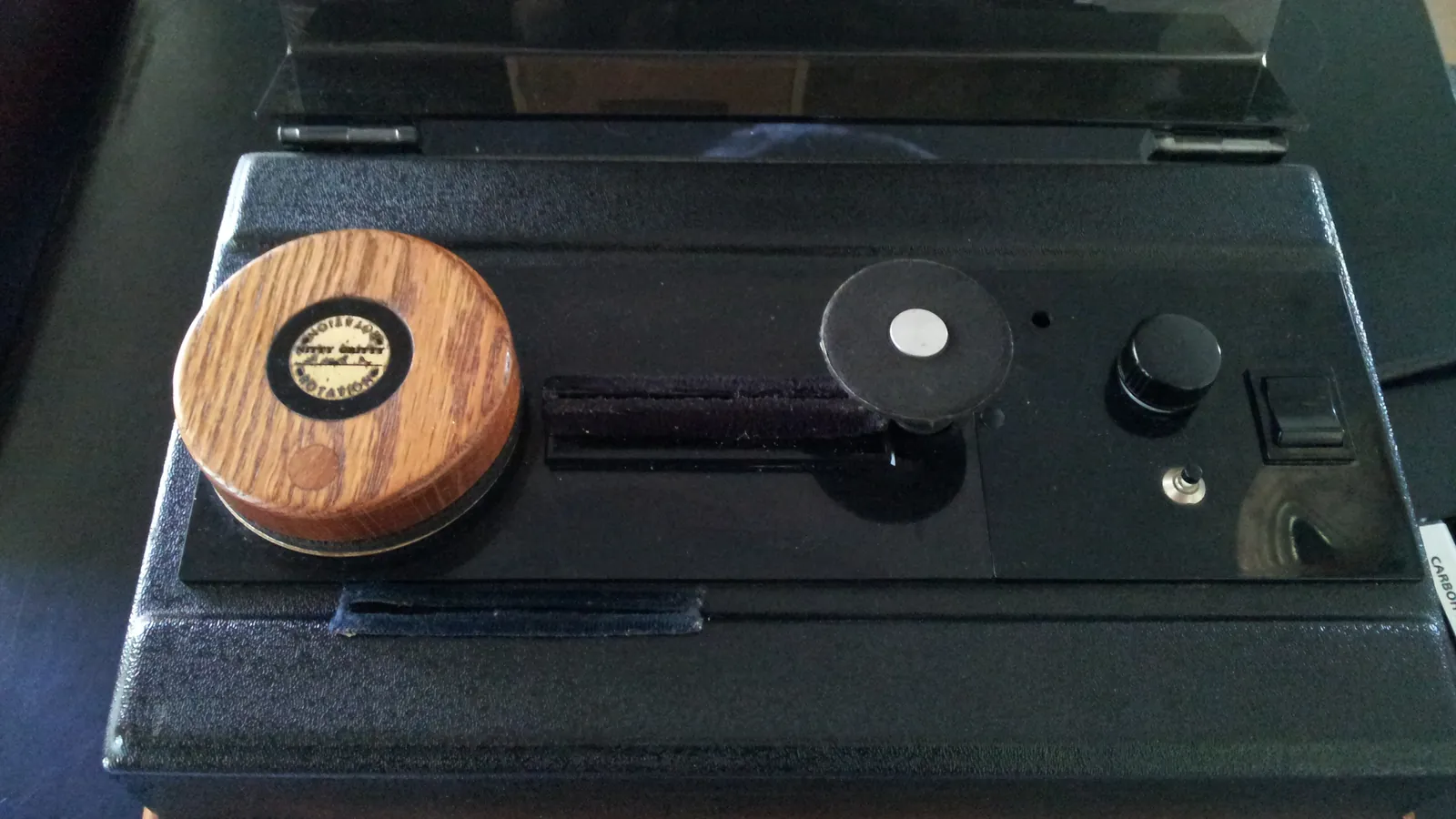 A Nitty Gritty record-cleaning machine with a vinyl LP resting on top of it