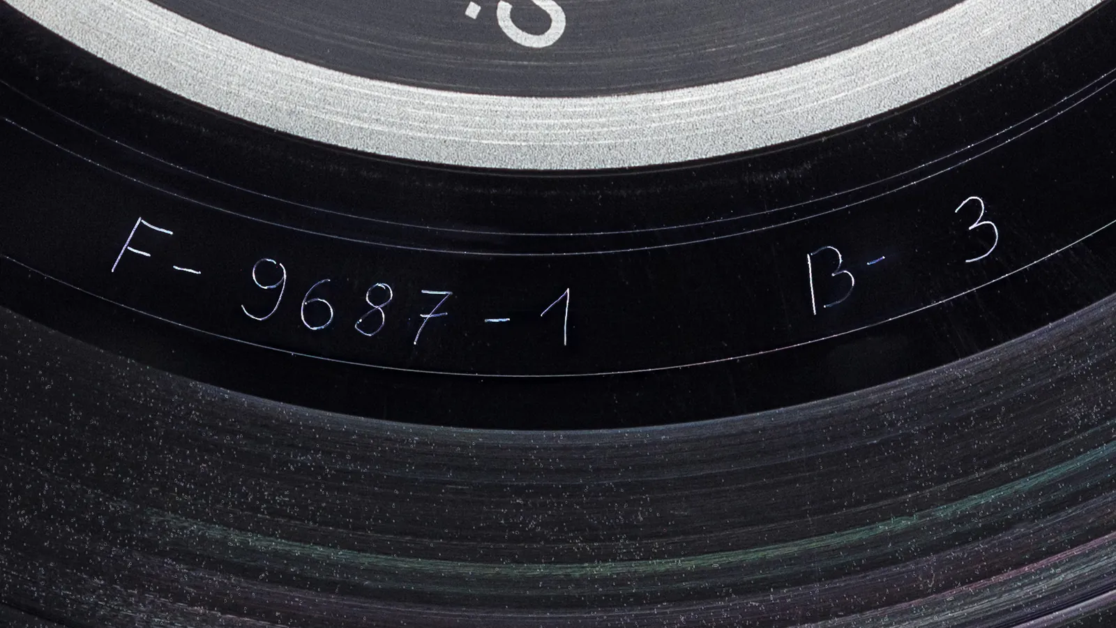 Macro photo of a matrix number etched into the runout groove of a vinyl LP