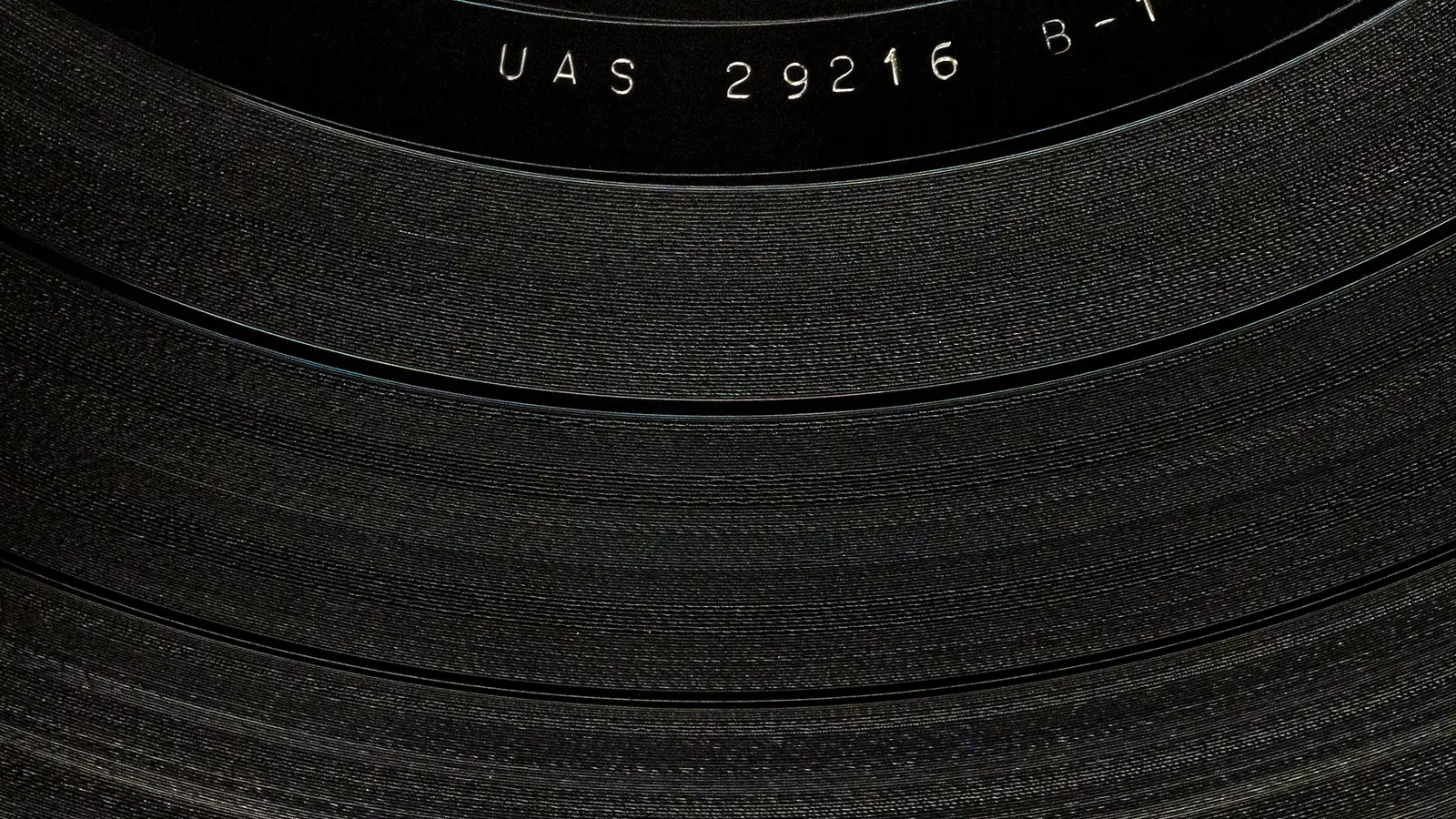 Macro photo of a matrix number etched into the runout groove of a vinyl LP