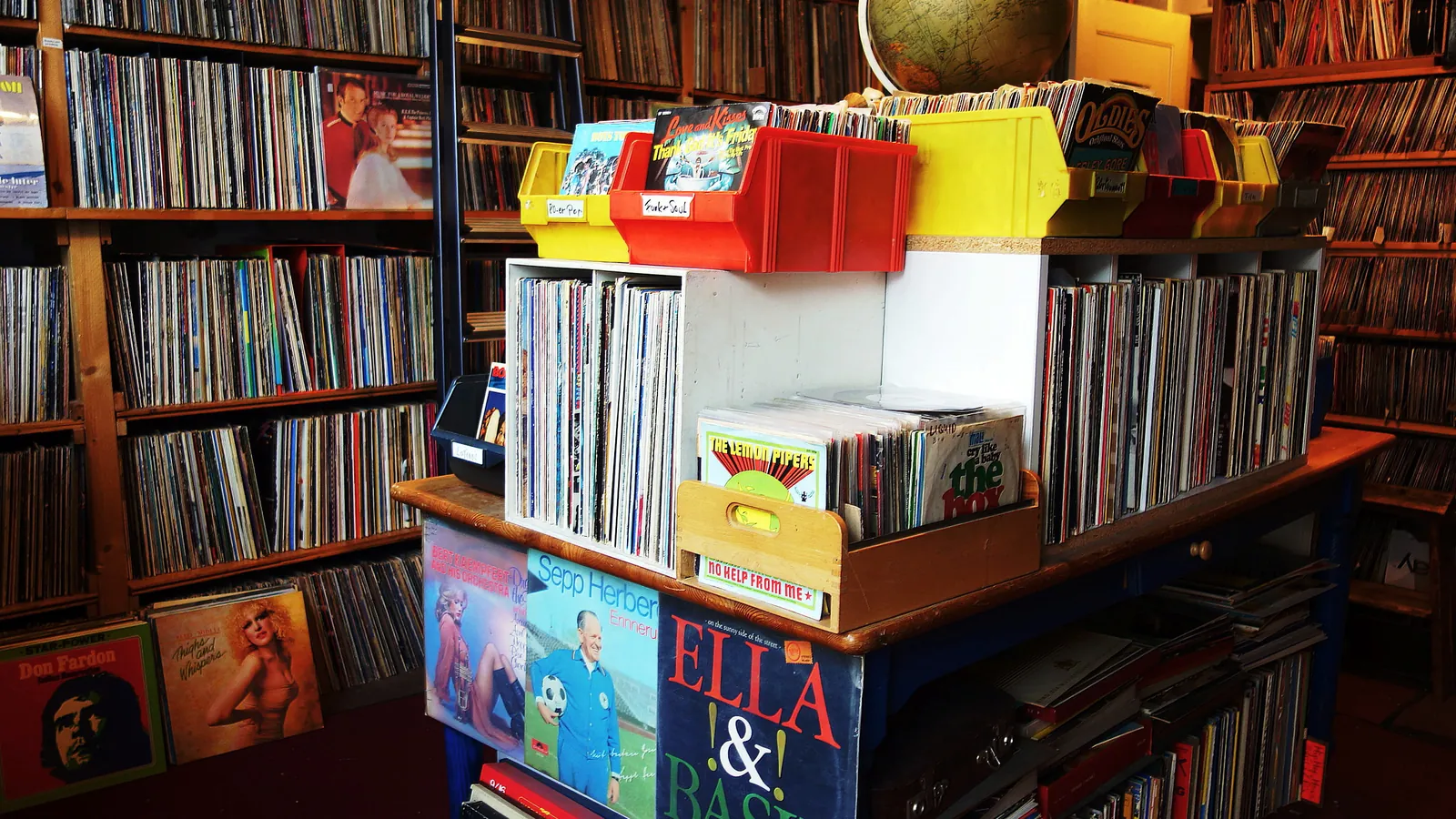 Floor-to-ceiling crates and shelves of vinyl records inside Platten-Pedro, an independent record shop in Berlin