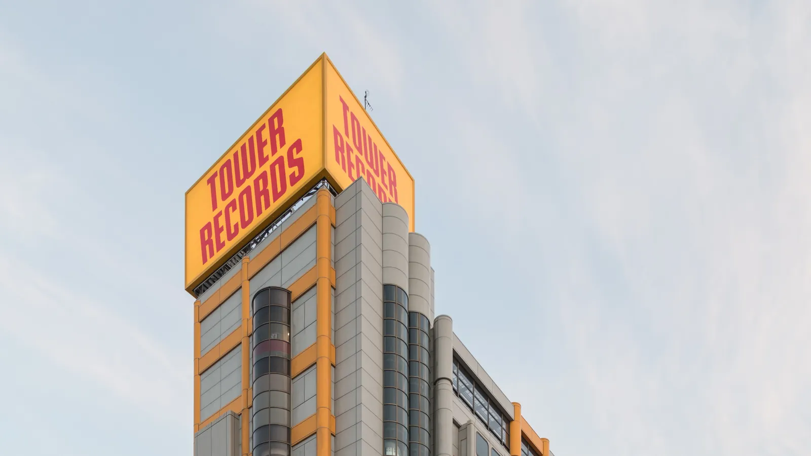 The yellow and red TOWER RECORDS sign atop the company's flagship building in Shibuya, Tokyo